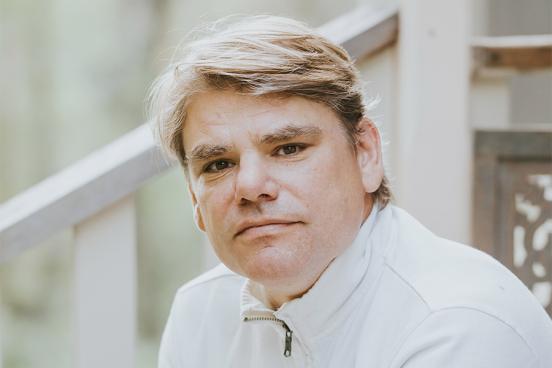 Snowboarding coach David Bloch headshot in white polo