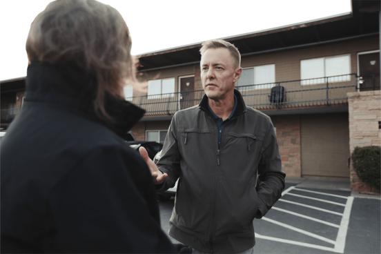 Mike Johnson of Yakima Union Gospel Mission talks with someone in a parking lot