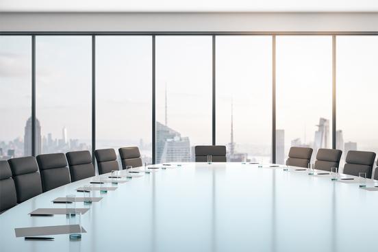 Board Room with notes and glasses overlooking city skyline