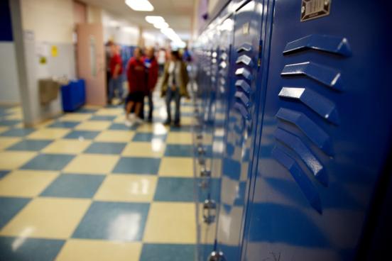 A row of blue lockers lines a school hallway