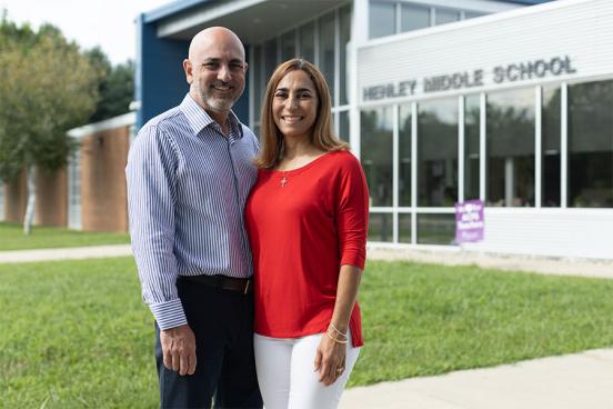 Carlos and Tatiana Ibanez standing in front of Henley Middle School