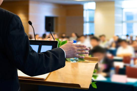 A lecturer addresses a college classroom