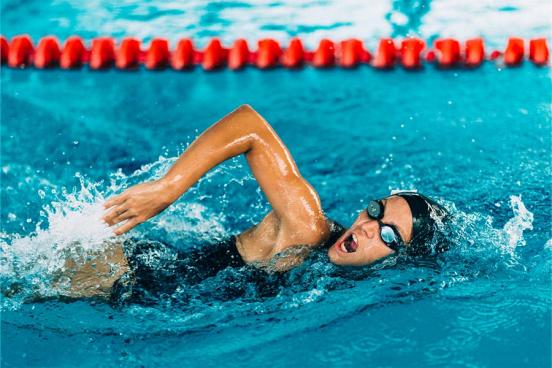 A woman swims competitively in a pool