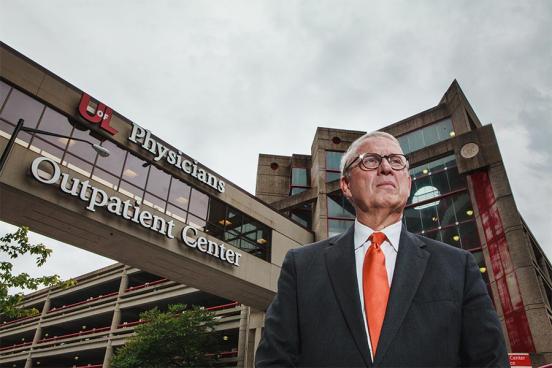 Dr. Allan Josephson stands outside the University of Louisville Health Outpatient Center on a cloudy day