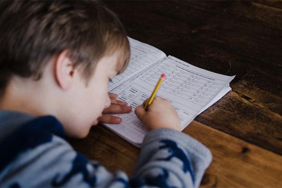 A boy student doing his homework