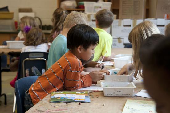 Young Students Drawing and Coloring in Class