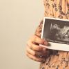 pregnant woman holding ultrasound