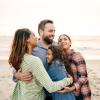 Parents hugging children on the beach