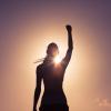 Victorious female athlete with fist raised