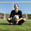 Lainey Armistead sitting with soccer ball