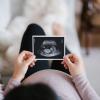 Pregnant mother looking at an ultrasound of her baby