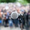 A microphone is seen set up before a crowd