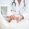 Doctor holding the hands of a female patient