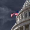 The dome of the U.S. Capitol is seen against a dark, cloudy sky