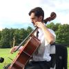 Indiana music and orchestra teacher John Kluge playing the cello outdoors