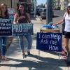 Sidewalk counselors with Right to Life of Central California stand with signs on a sidewalk