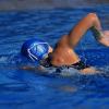 A female swimmer is seen in the pool