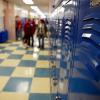 A row of blue lockers lines a school hallway