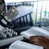 A microphone and Bible sit on a broadcaster's desk