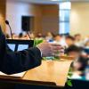 A lecturer addresses a college classroom