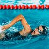 A woman swims competitively in a pool