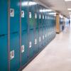 Blue lockers line an empty school hallway