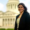 Amelia Ford stands smiling in front of the Arkansas State Capitol