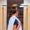 A girl with a towel looking for a shower in a Rapides Parish shower room