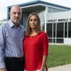 Carlos and Tatiana Ibanez stand in front of Henley Middle School with serious expressions on their faces